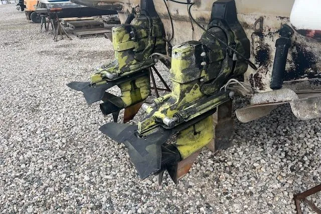 Slide: The Image of 1993 Maxum 2700 SCR boat with dual outboard motors on gravel. - 3