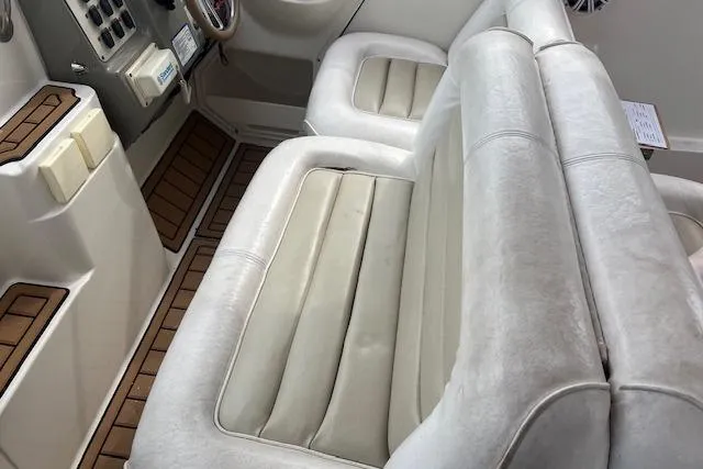 Slide: The Image of 1993 Maxum 2700 SCR boat interior with white cushioned seating and wood accents. - 5