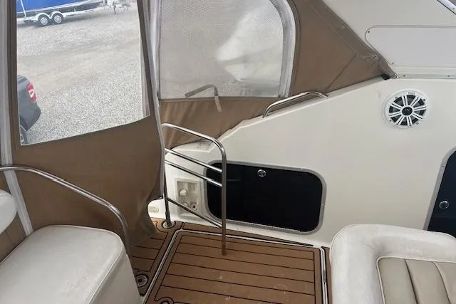Slide: The Image of 1993 Maxum 2700 SCR boat interior with seating and wood flooring. - 7