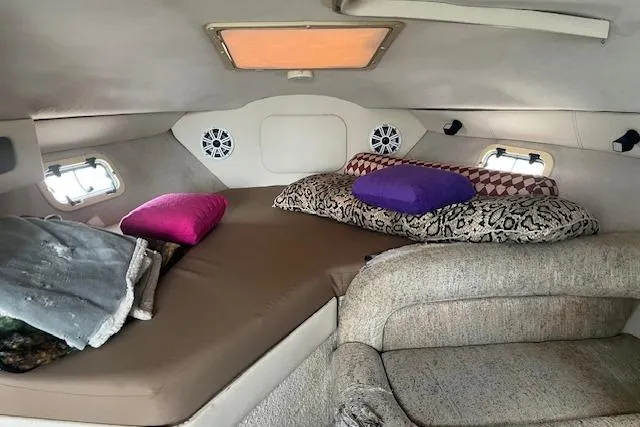 Slide: The Image of Cozy cabin interior of 1993 Maxum 2700 SCR boat with cushions and pillows. - 8