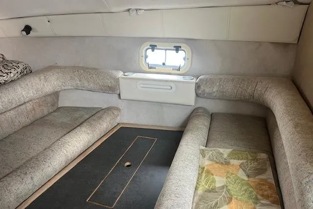 Slide: The Image of Interior cabin of 1993 Maxum 2700 SCR boat with cozy seating and small window. - 9