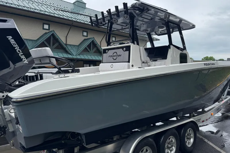 Slide: The Image of 2023 Fountain 38 CC Tournament Edition boat on trailer, featuring Mercury engine. - 12