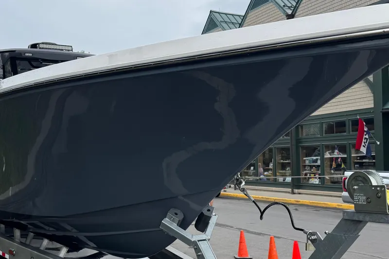 Slide: The Image of 2023 Fountain 38 CC Tournament Edition boat on trailer, parked near a building. - 14