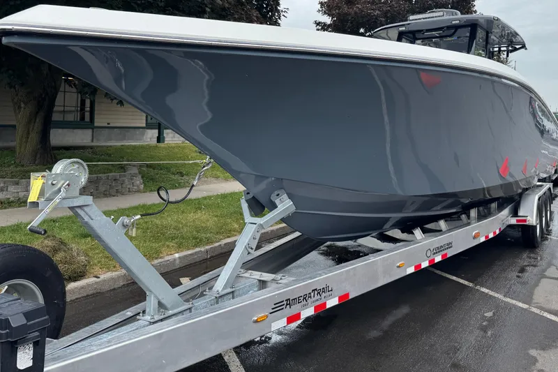 Slide: The Image of 2023 Fountain 38 CC Tournament Edition boat on trailer, parked outdoors. - 16