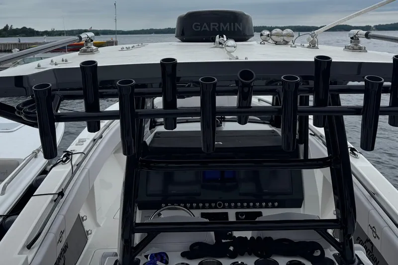 Slide: The Image of 2023 Fountain 38 CC Tournament Edition boat with Garmin equipment, docked by the water. - 24