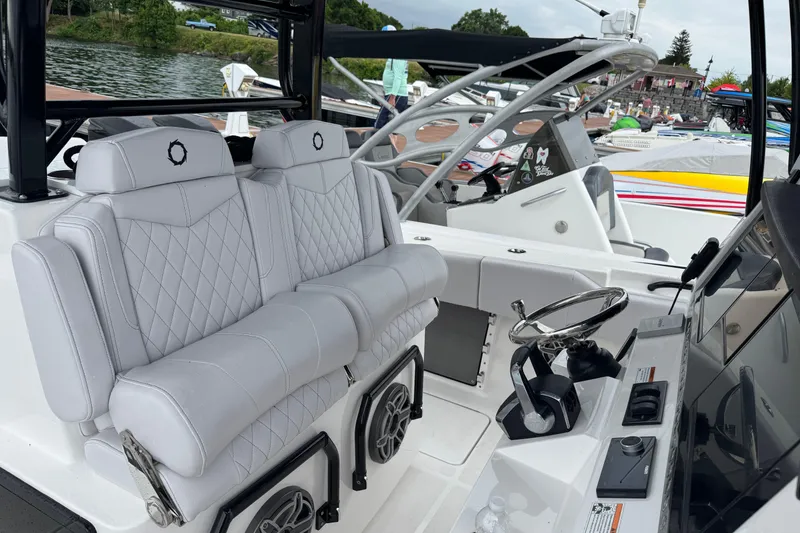 Slide: The Image of 2023 Fountain 38 CC Tournament Edition boat interior with luxurious seating and steering console. - 28