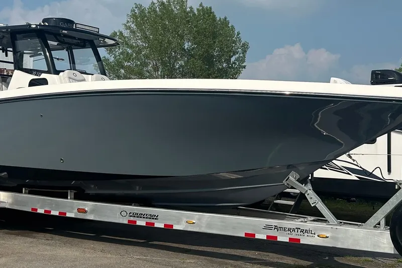 Slide: The Image of 2023 Fountain 38 CC Tournament Edition boat on trailer, sleek design, parked outdoors. - 3