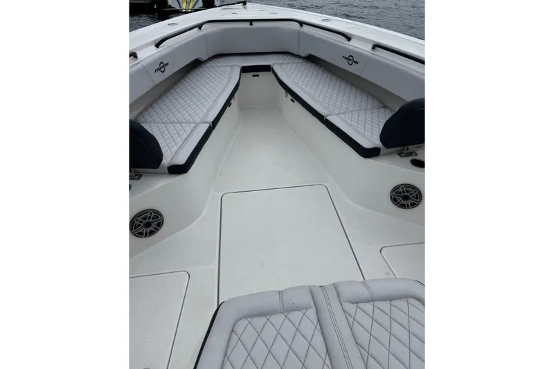 Slide: The Image of 2023 Fountain 38 CC Tournament Edition boat interior with cushioned seating and speakers. - 32