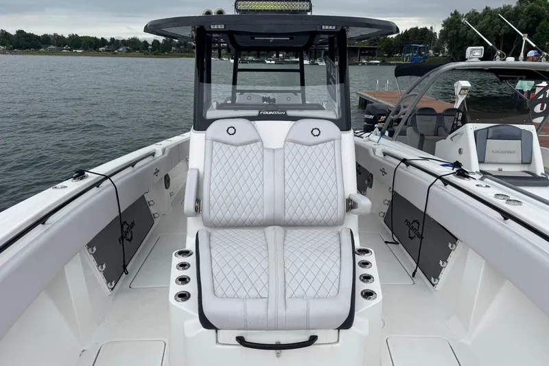 Slide: The Image of 2023 Fountain 38 CC Tournament Edition boat with white seating on the water. - 34