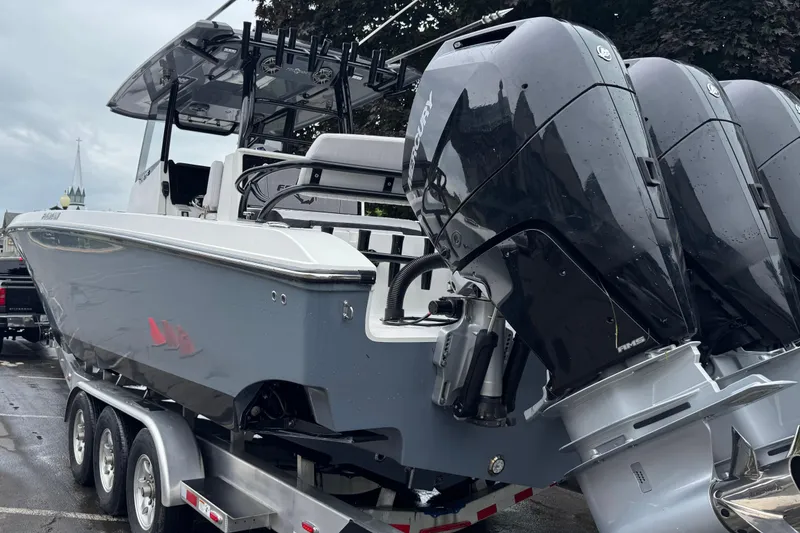 Slide: The Image of 2023 Fountain 38 CC Tournament Edition boat with triple Mercury engines on trailer. - 5