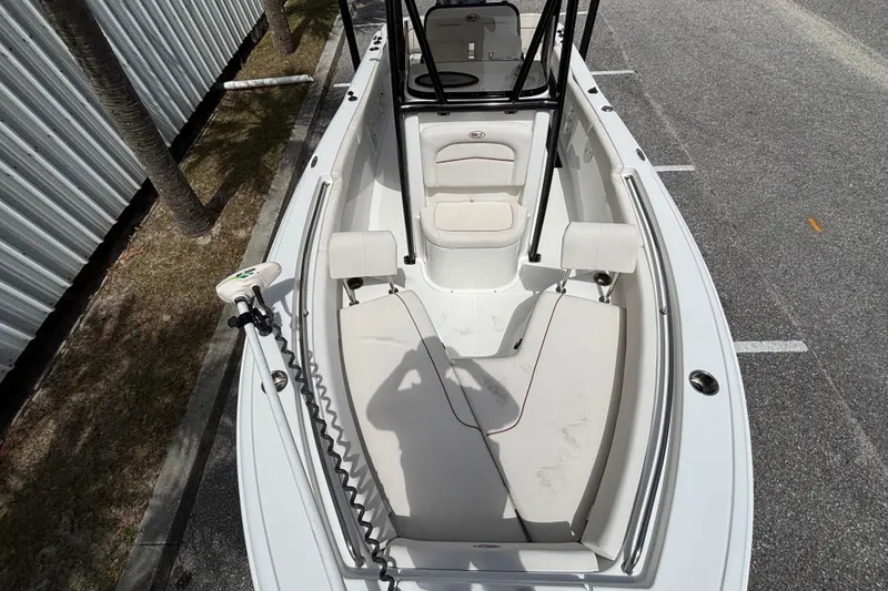 Slide: The Image of 2021 Sea Hunt Ultra 219 boat interior with seating and trolling motor. - 11