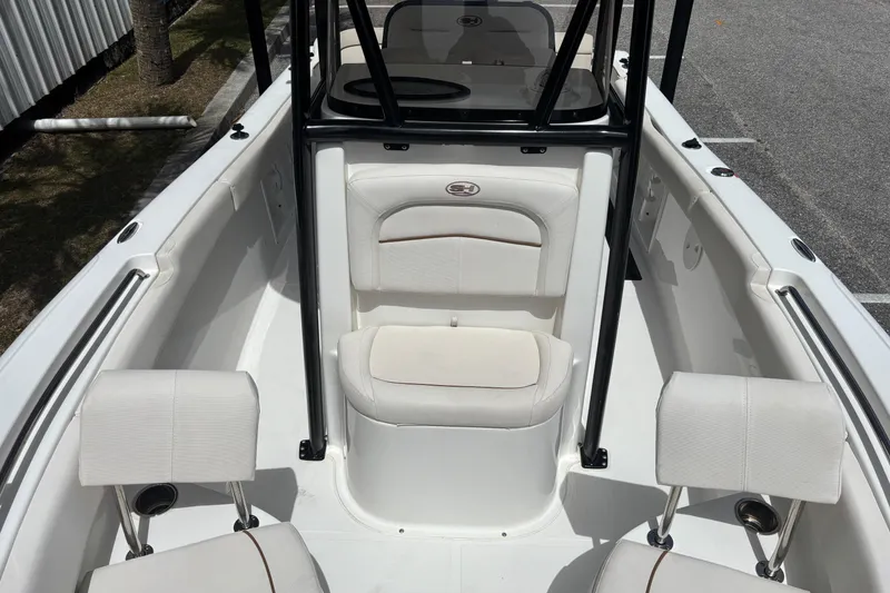 Slide: The Image of 2021 Sea Hunt Ultra 219 boat interior with white seating and black frame. - 12