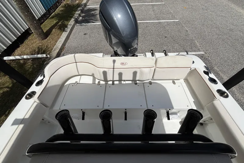 Slide: The Image of 2021 Sea Hunt Ultra 219 boat interior with seating and rod holders. - 16