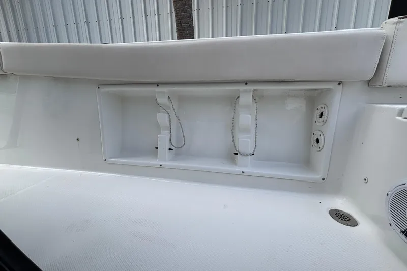 Slide: The Image of 2021 Sea Hunt Ultra 219 boat interior with storage compartment and seating. - 18