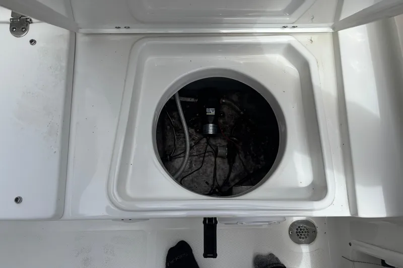 Slide: The Image of Open hatch of a 2021 Sea Hunt Ultra 219 boat showing internal wiring. - 19