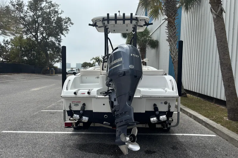 Slide: The Image of 2021 Sea Hunt Ultra 219 boat with Yamaha 150 engine in parking lot. - 2