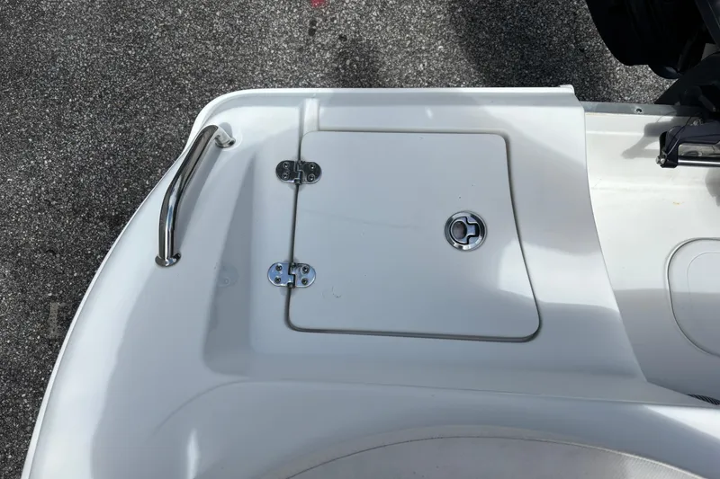 Slide: The Image of 2021 Sea Hunt Ultra 219 boat deck with storage hatch and stainless steel handle. - 22