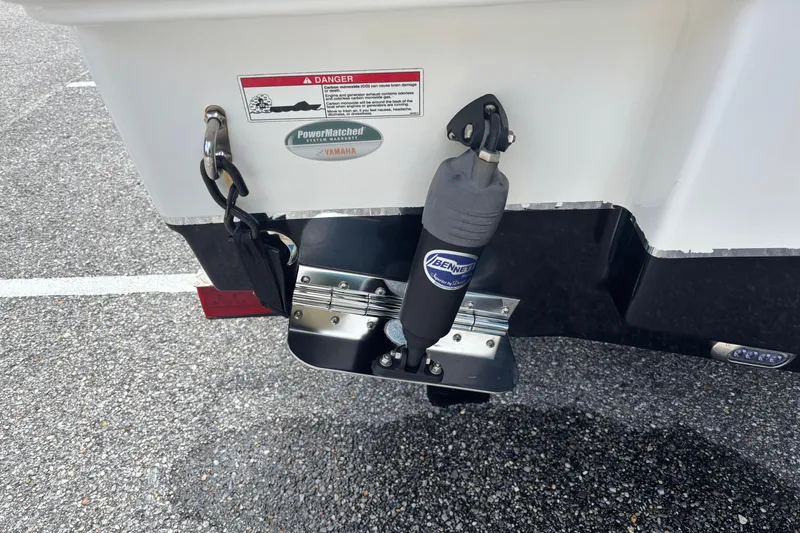 Slide: The Image of Rear view of 2021 Sea Hunt Ultra 219 boat with trim tab and warning label. - 25