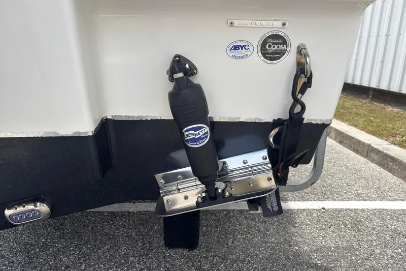 Slide: The Image of Rear view of a 2021 Sea Hunt Ultra 219 boat with trim tab and hydraulic system. - 27