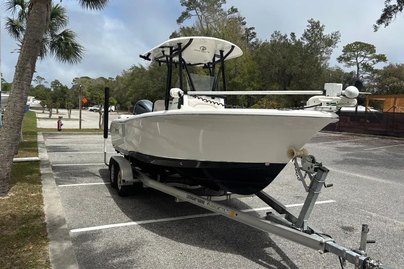 Slide: The Image of 2021 Sea Hunt Ultra 219 boat parked on trailer outdoors. - 4