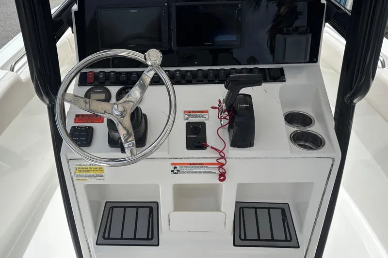 Slide: The Image of 2021 Sea Hunt Ultra 219 boat console with steering wheel and controls. - 7