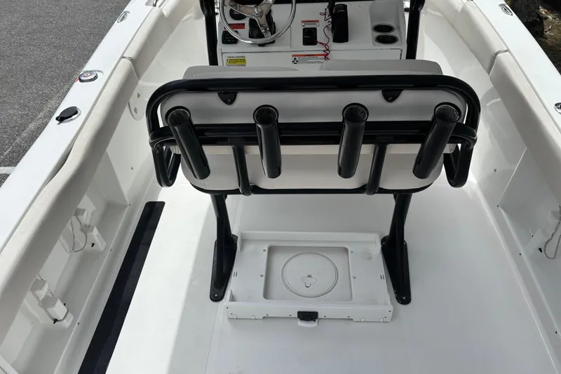 Slide: The Image of 2021 Sea Hunt Ultra 219 boat interior with rod holders and steering console. - 9