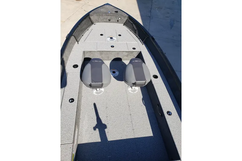 Slide: The Image of 2026 Alumacraft Classic 165 Tiller boat interior with two seats and gray flooring. - 11