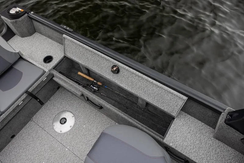 Slide: The Image of 2026 Alumacraft Classic 165 Tiller boat interior with fishing rod storage. - 17