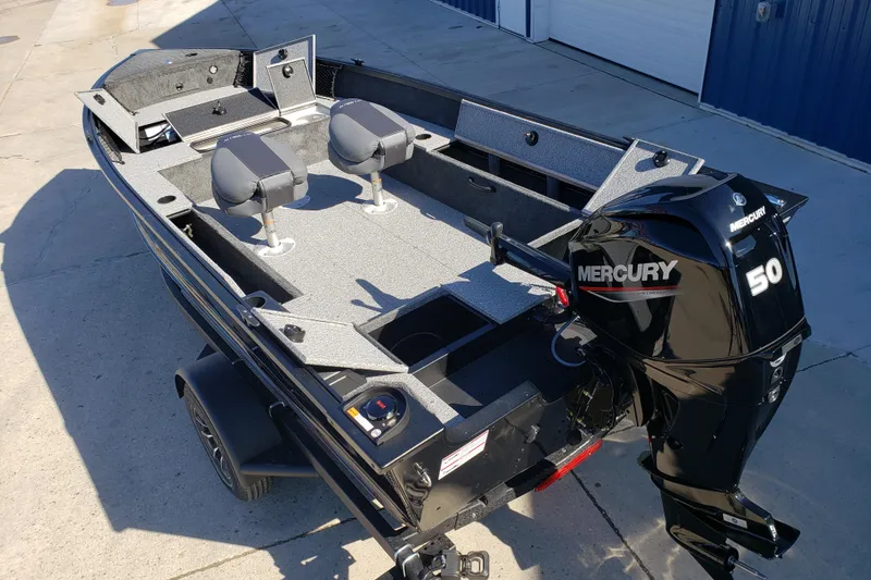 Slide: The Image of 2026 Alumacraft Classic 165 Tiller boat with Mercury 50 engine, parked on concrete. - 8
