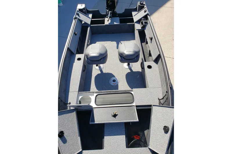 Slide: The Image of 2026 Alumacraft Classic 165 Tiller boat interior with seating and storage compartments. - 9