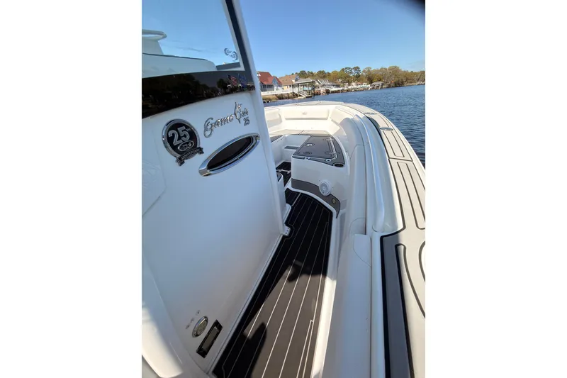 Slide: The Image of 2021 Sea Hunt Gamefish 25 boat deck with sleek design on calm water. - 10