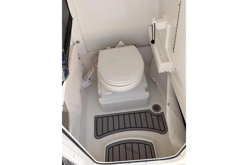 Slide: The Image of 2021 Sea Hunt Gamefish 25 boat interior with marine toilet and non-slip flooring. - 12