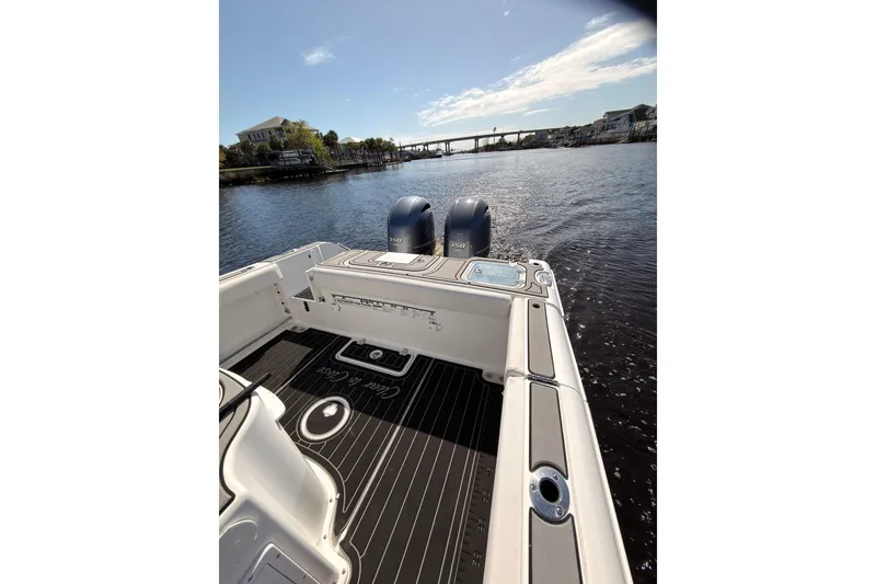 Slide: The Image of 2021 Sea Hunt Gamefish 25 boat on calm water with dual engines. - 15