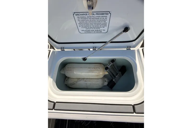 Slide: The Image of Storage compartment on a 2021 Sea Hunt Gamefish 25 boat with fenders and equipment. - 17
