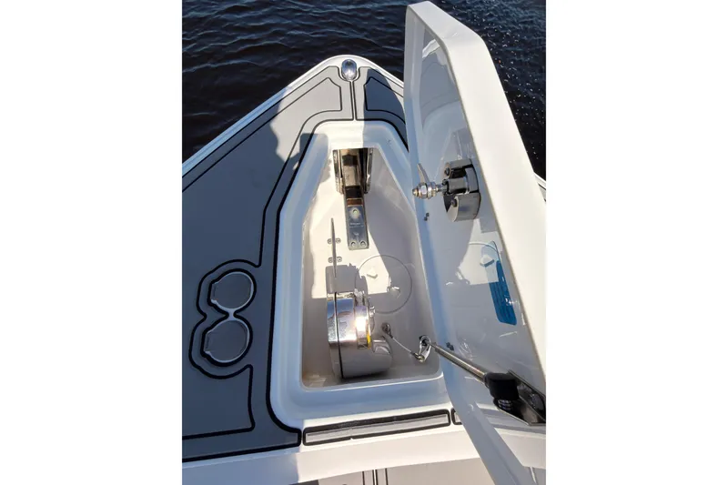 Slide: The Image of 2021 Sea Hunt Gamefish 25 boat anchor compartment with open hatch, showing interior details. - 19
