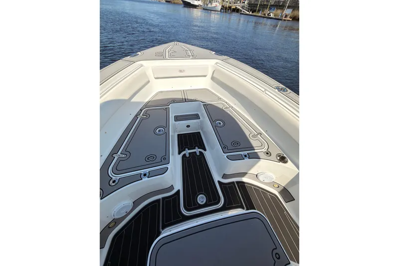 Slide: The Image of 2021 Sea Hunt Gamefish 25 boat deck, featuring sleek design and spacious layout on the water. - 5