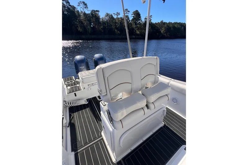 Slide: The Image of 2021 Sea Hunt Gamefish 25 boat interior with dual engines on a sunny day. - 6