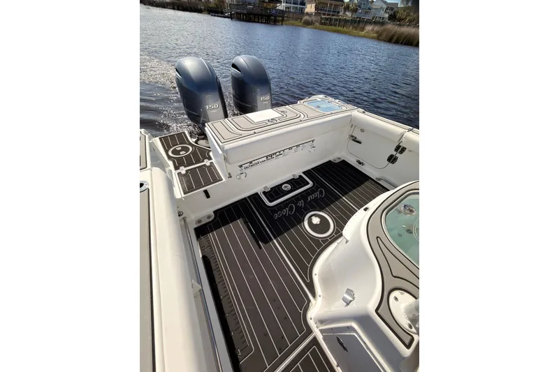Slide: The Image of 2021 Sea Hunt Gamefish 25 boat deck with twin 150 engines on a calm waterway. - 7