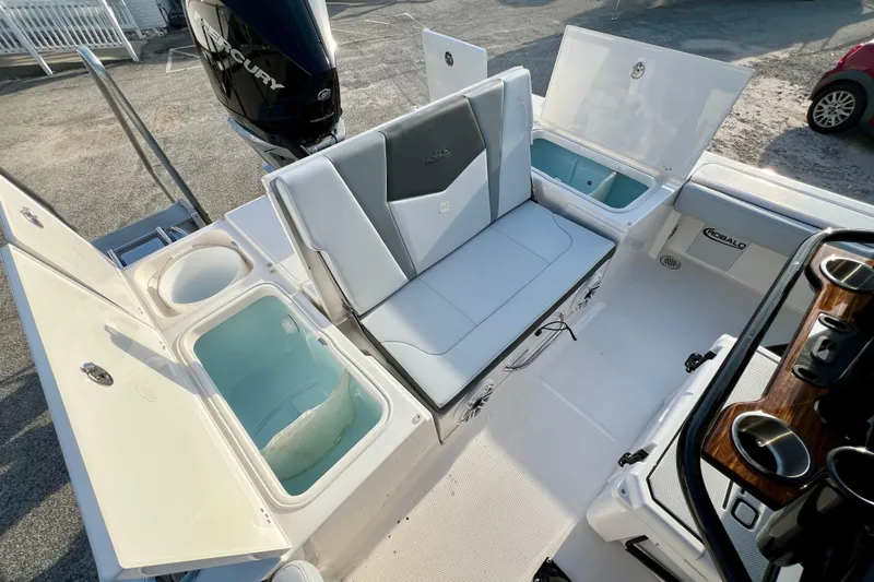 Slide: The Image of 2026 Robalo 246 Cayman boat interior with seating, storage, and Mercury engine. - 11