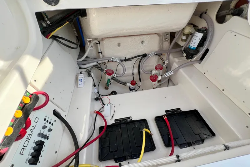 Slide: The Image of Interior view of 2026 Robalo 246 Cayman boat's engine compartment with wiring and components. - 14