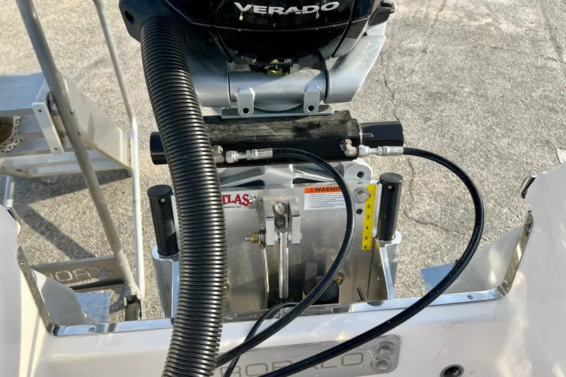 Slide: The Image of 2026 Robalo 246 Cayman boat engine detail with Verado motor and hydraulic components. - 15