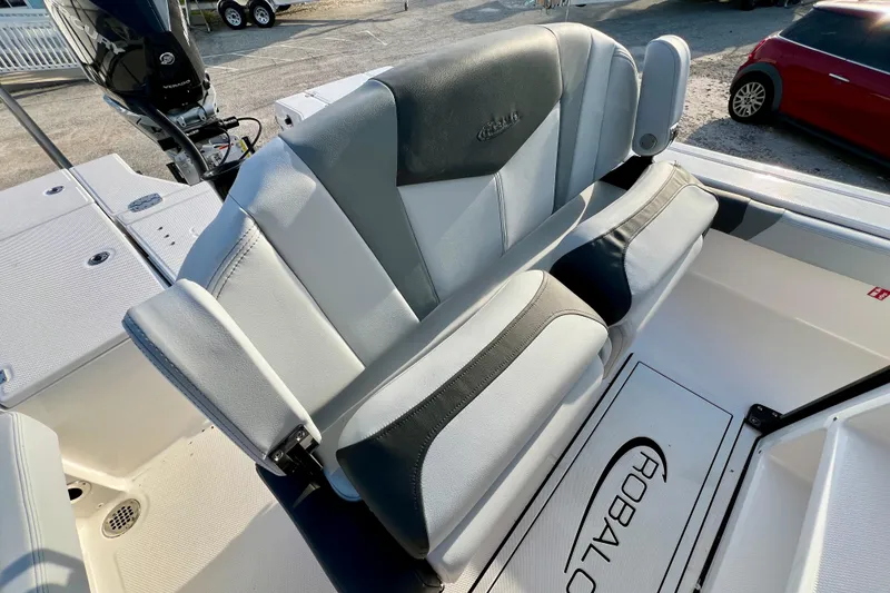 Slide: The Image of 2026 Robalo 246 Cayman boat seating with gray and white upholstery. - 17