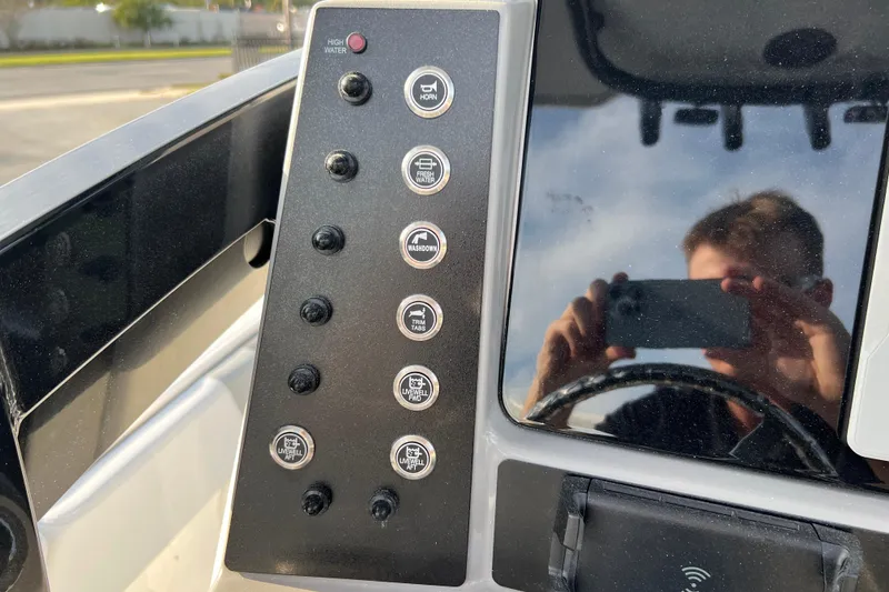 Slide: The Image of Control panel of 2026 Robalo 246 Cayman boat with various function buttons. - 20