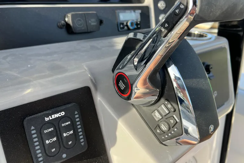 Slide: The Image of Close-up of 2026 Robalo 246 Cayman boat controls and throttle. - 21