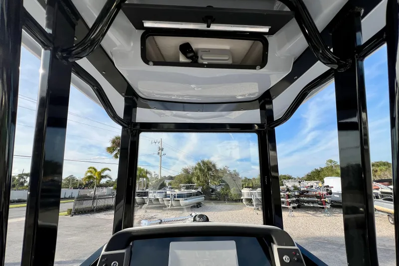 Slide: The Image of Interior view of 2026 Robalo 246 Cayman boat, showcasing helm and overhead console. - 22