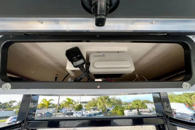 Slide: The Image of 2026 Robalo 246 Cayman boat with Garmin electronics and microphone setup. - 23