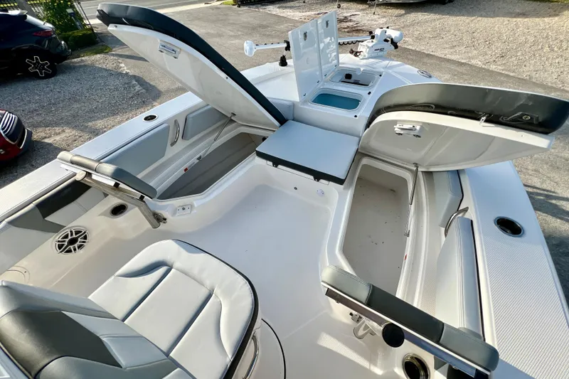 Slide: The Image of 2026 Robalo 246 Cayman boat interior with open storage compartments and seating. - 27