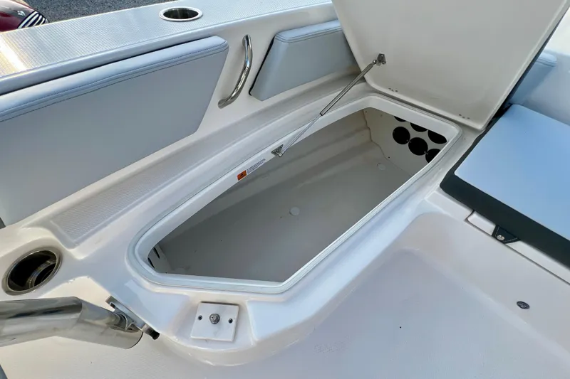 Slide: The Image of Open storage compartment on 2026 Robalo 246 Cayman boat, showcasing interior space. - 28
