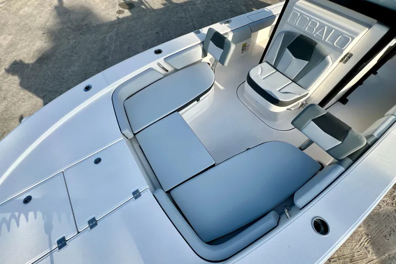 Slide: The Image of 2026 Robalo 246 Cayman boat interior with cushioned seating and sleek design. - 31