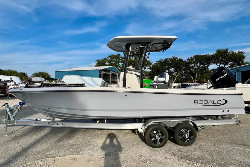 Slide: The Image of 2026 Robalo 246 Cayman boat on trailer, clear sky background. - 5